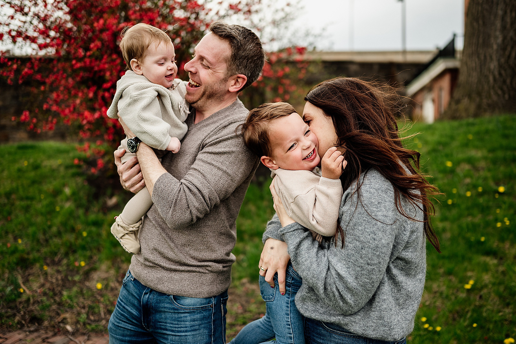 A family snuggles during their boston family photography session captured by west roxbury family photographer korri leigh crowley