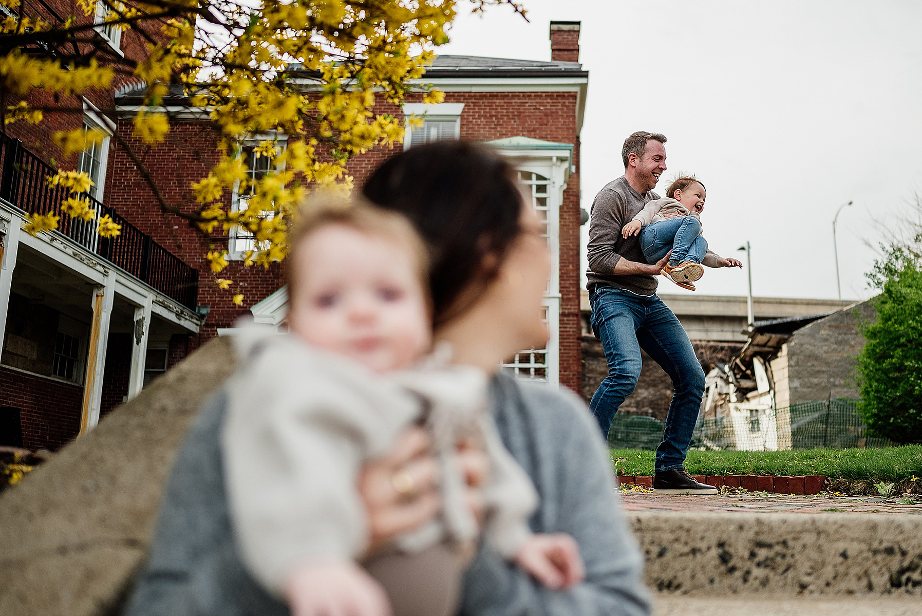 A family plays during their boston family photography session captured by west roxbury family photographer korri leigh crowley