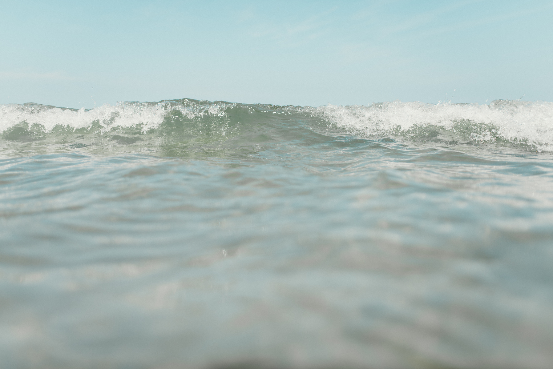 a crashing wave approaches at rexhame beach in marshfield