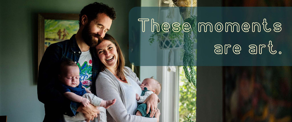 A mother and father smile and laugh while holding their twin babies
