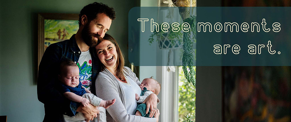 A mother and father smile and laugh while holding their twin babies