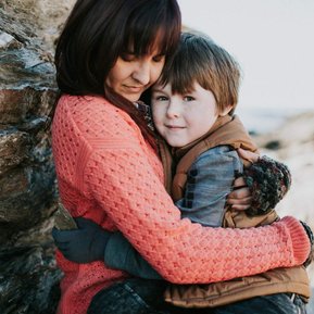 Boston family photographer Korri Leigh crowley hugs her son while wearing a pink sweater