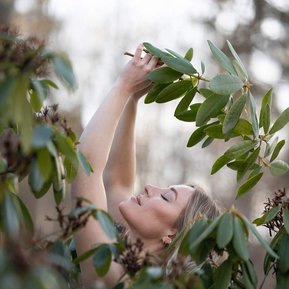 Portrait of woman holding plants. Stockholm, Sweden. Boudoir photography by the Beast Goddess.