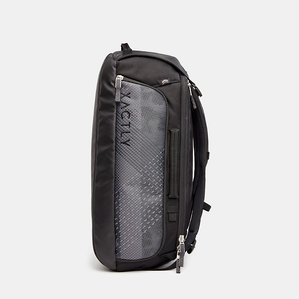 side view of black grey and blue utility outdoor backpack with straps hanging on white background