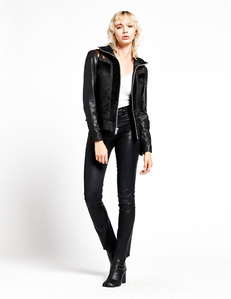 female model with short blonde shag hairstyle  wearing an black leather jacket pants and boots with a white background for e commerce catalog product