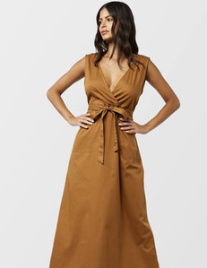 female model with long brunette hairstyle  wearing an rust gold flowing fitting dress with a white background for e commerce catalog product