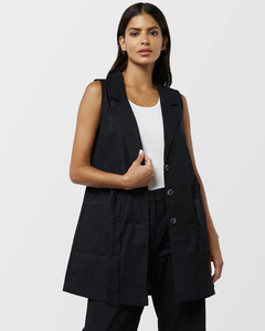 female model with long brunette hairstyle  wearing an black loose fitting vest pants with a white background for e commerce catalog product