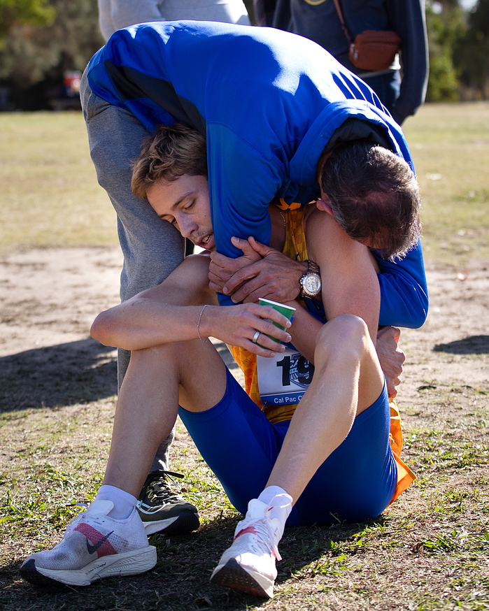 Paul Hoerl hugs his son just seconds after he crossed the finish line at the CalPac championships.