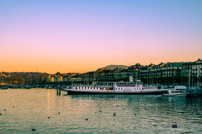 Colourful sunset or golden hour photography with a small ship in the frame, Geneva