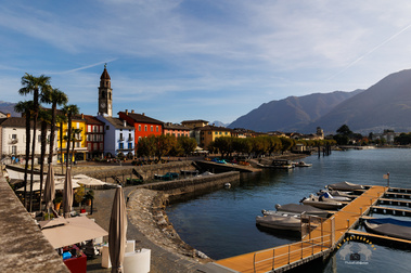 Scenic lake side view of  Lago Maggiore with shops, restaurants and hotels along the coast. Ascona