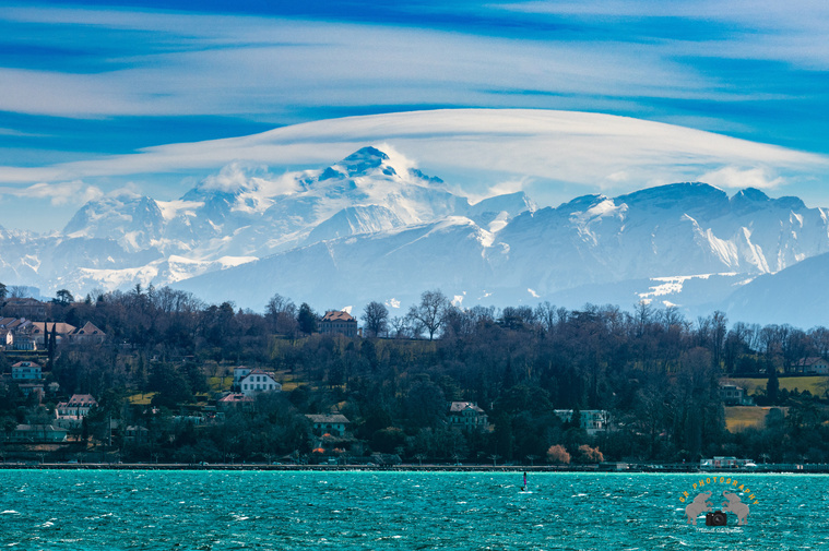 Beautiful scenic view of Lac Léman and French Alps. This looks like Aura formed on the top of the Alps. Geneva