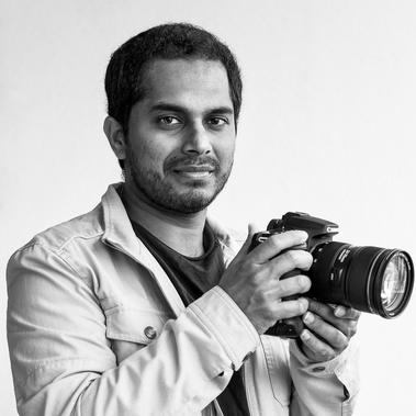 Self portrait of Ganesh Gopalan from GR Photography posing with a camera in his hand.