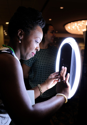 While attending her first convention, FAMU Senior, Karah Bailey, interacts with a photo exhibit at the NABJ 2017 Annual Convention in New Orleans on Aug. 10, 2017. with (Katherine C. Gilyard/NABJ Monitor)