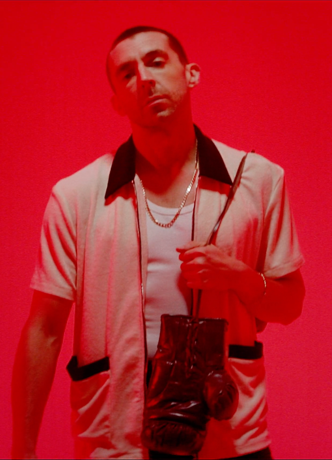 Red light on Miles Kane with a daylight overhead.