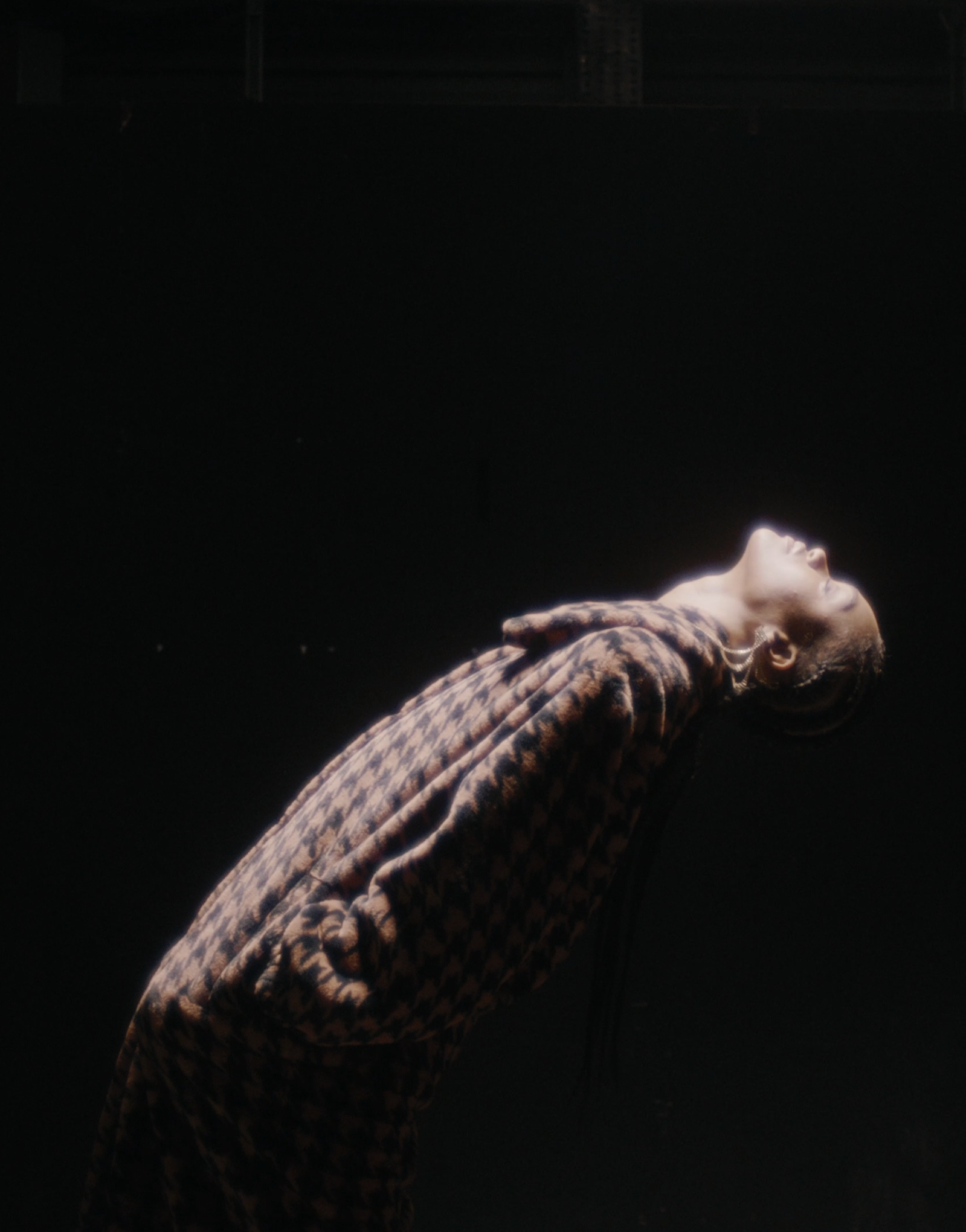 Soft overhead light on a model wearing the product. 