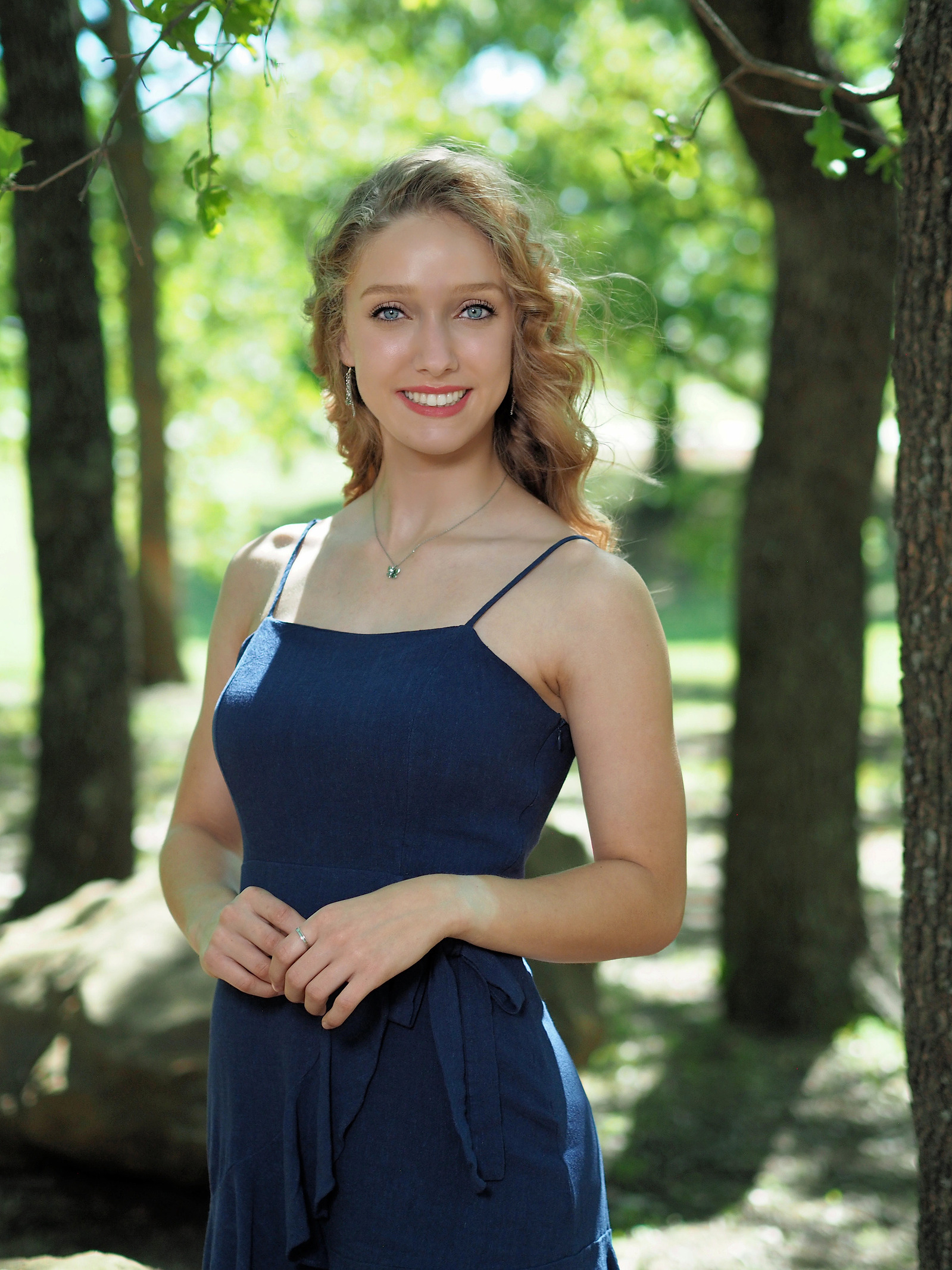 Senior Portrait of a teenage girl under trees using an ND filter and the EM5 II.