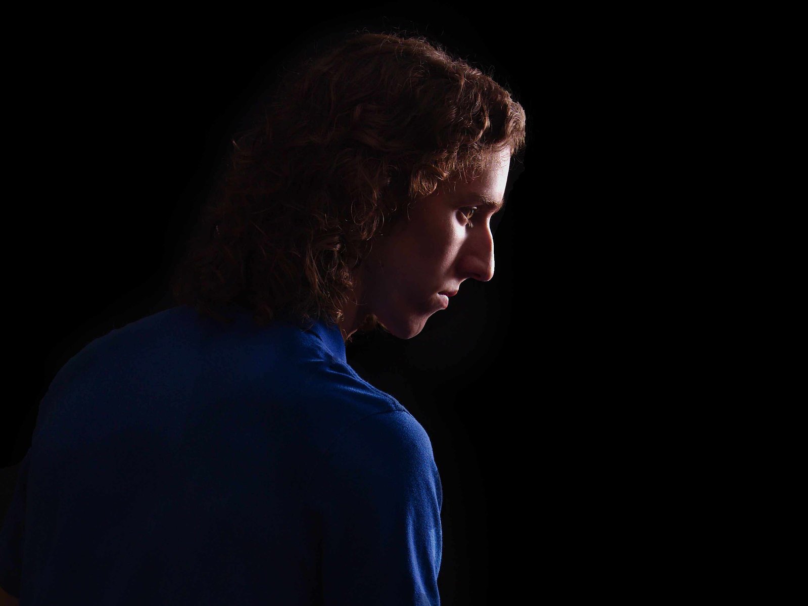 Image Description: "The cropped profile portrait of a Young Man on a black background."