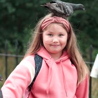 Girl in Hyde Park with bird on her head