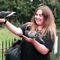 Young Lady feeding birds in Hyde Park