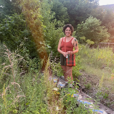 Michelle Lee Delgado exploring plant life in the undeveloped section of The Reading Terminal viaduct.
