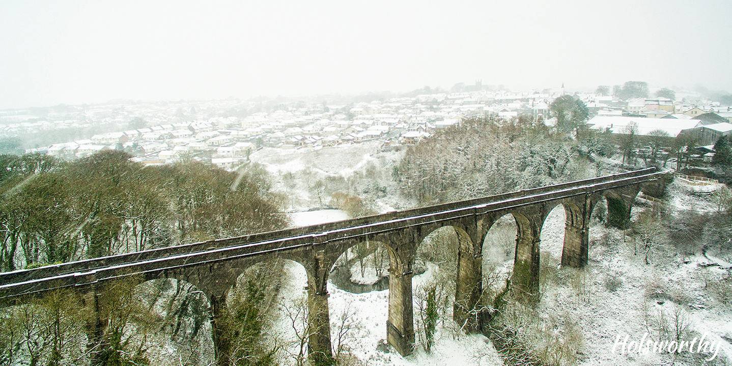 Holsworthy viaduct, railway, snow on ground. Aerial image.