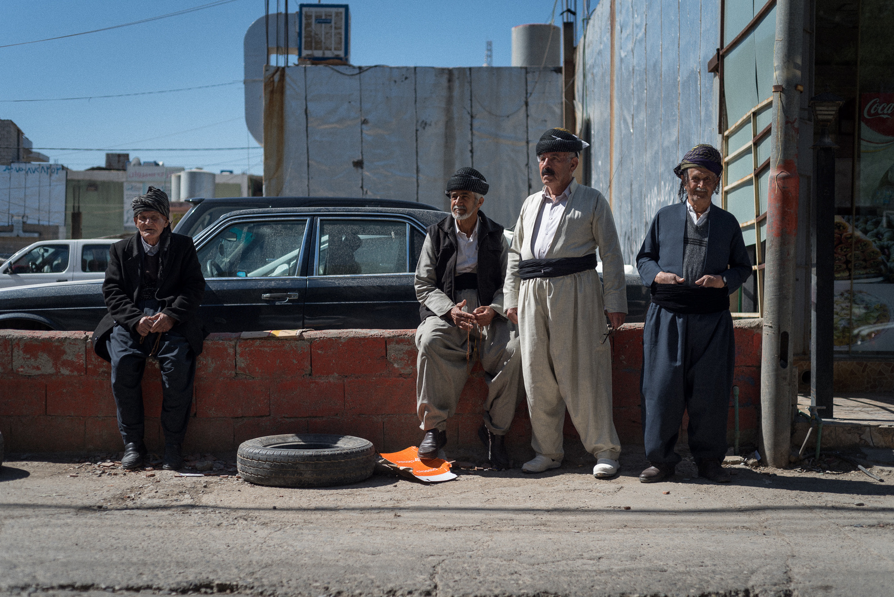 Halabja, KRI. A group of old men, dressed in the traditional Kurdish clothes, at the market in downtown Halabja. All of them are survivors of the chemical attack that hit the city on March 16th 1988. One of them just said: "I did not get any reparation, e