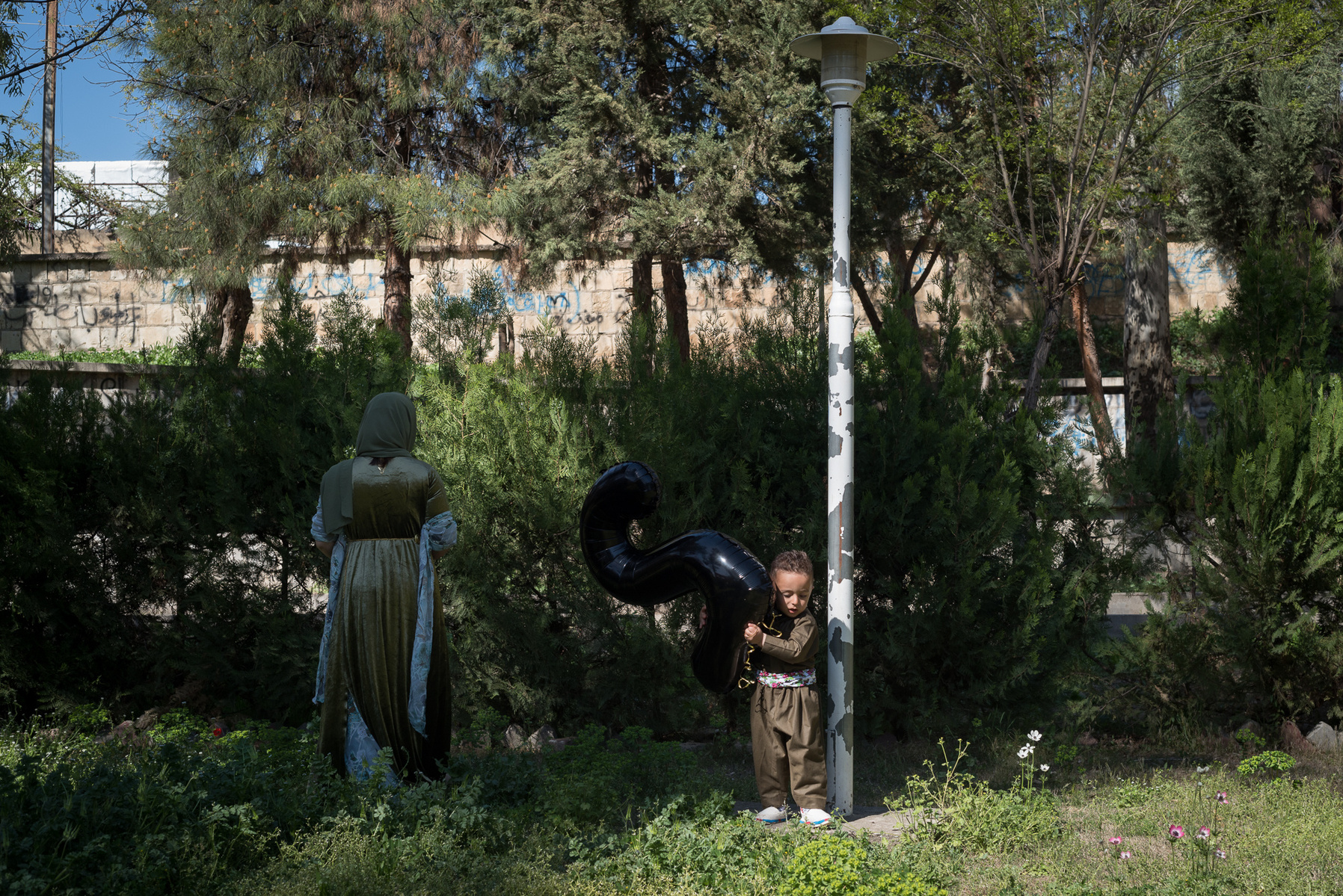 Halabja, KRI. Murad (2) and his mother in a park in Halabja are posing for pictures with their family members to celebrate Murad’s 2nd birthday. The city was hit by a chemical attack on March 16th 1988 and the collective trauma is still lingering.
