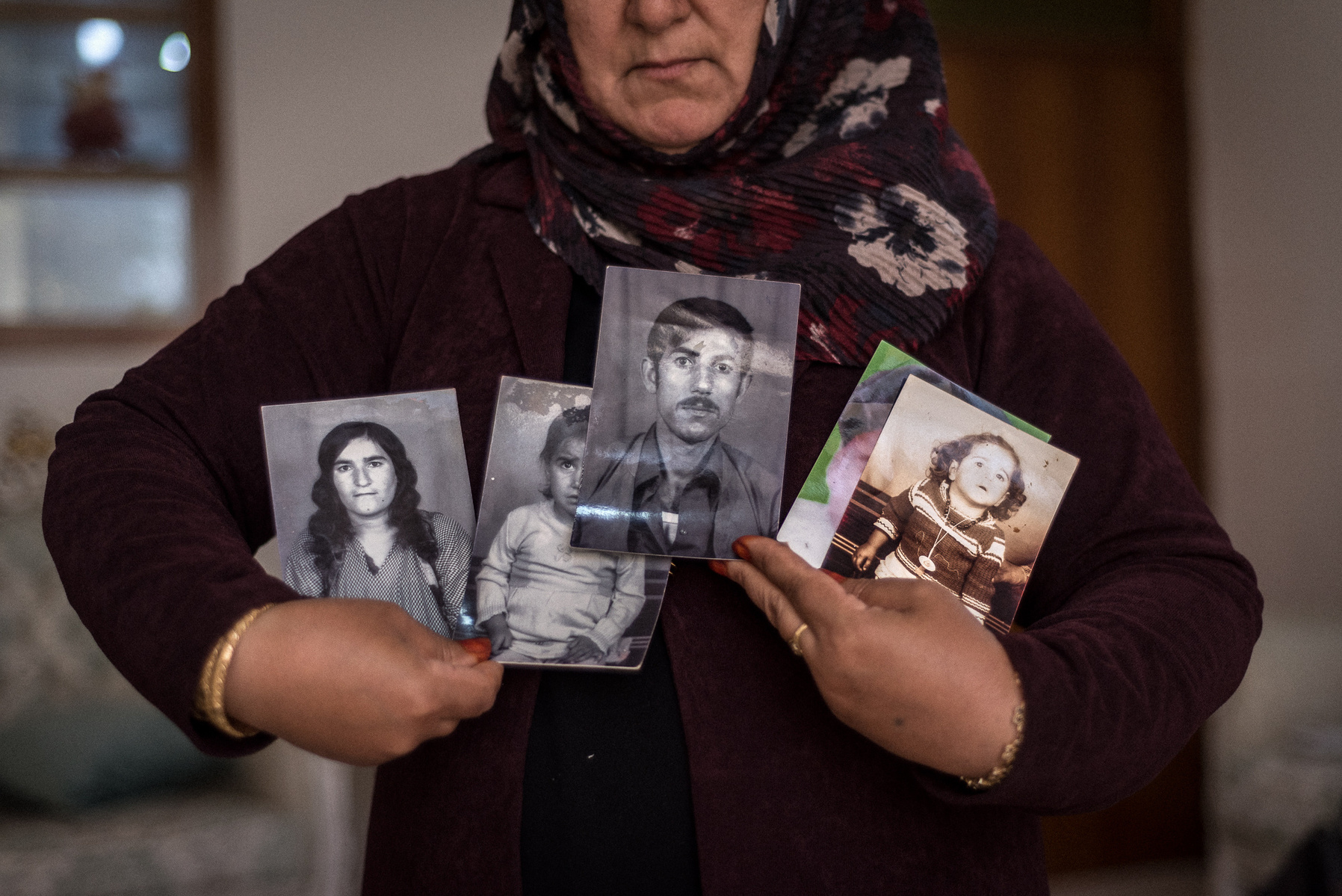 Halabja, KRI. Chro Taib Ali (43) shows the photos of the seven family members (her parents and siblings) she lost on the 16th of March 1988 as a result of the chemical attack on the city of Halabja by Saddam Hussein's forces. She is herself a survivor and