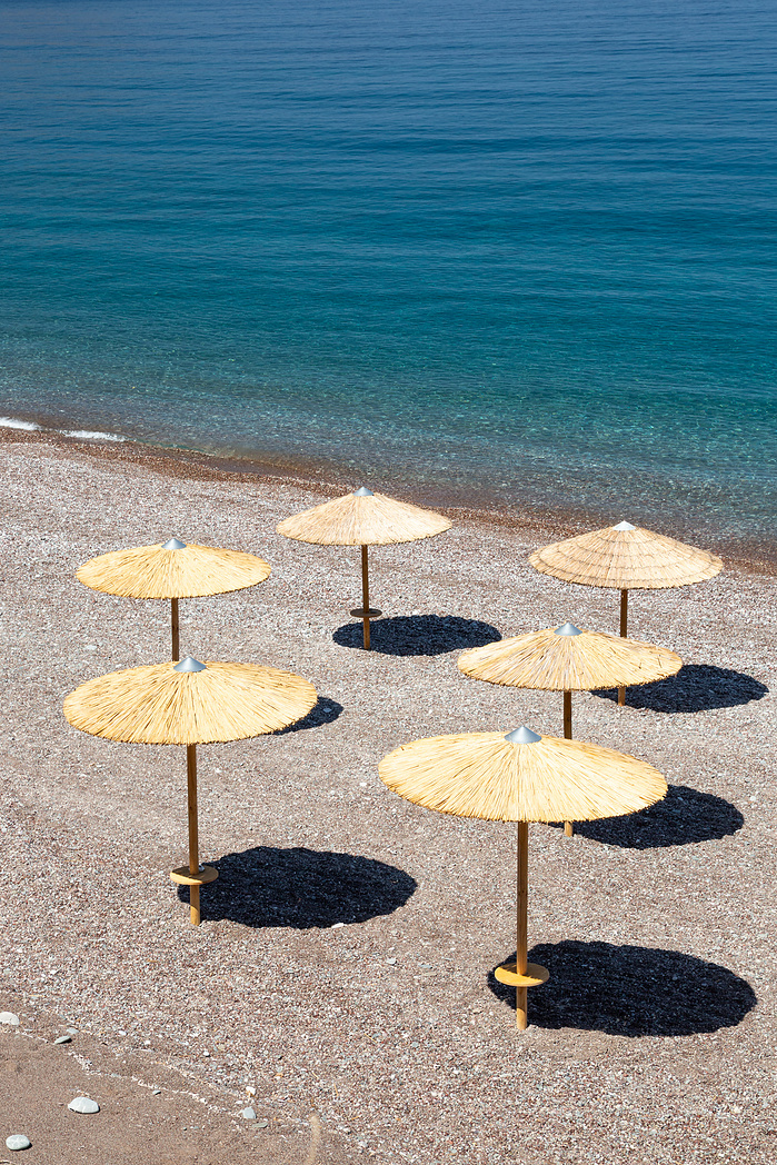 Umbrellas on empty beach Fyri Ammos Kythira Greece