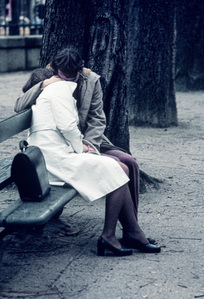 Couple in love embracing intimately on a bench.
