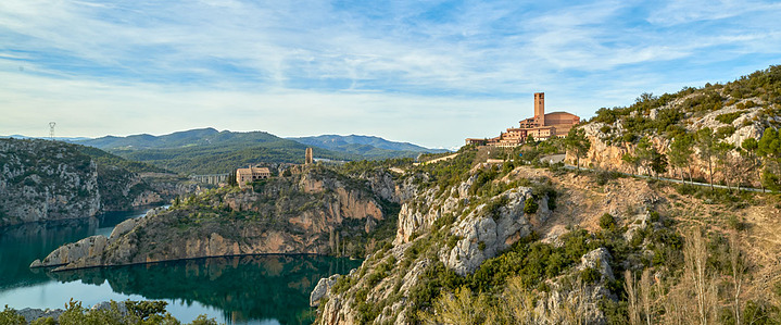 Torreciudad Sanctuary, nestled in the Spanish Pyrenees, blends modern brick architecture with serene natural surroundings above El Grado Reservoir.