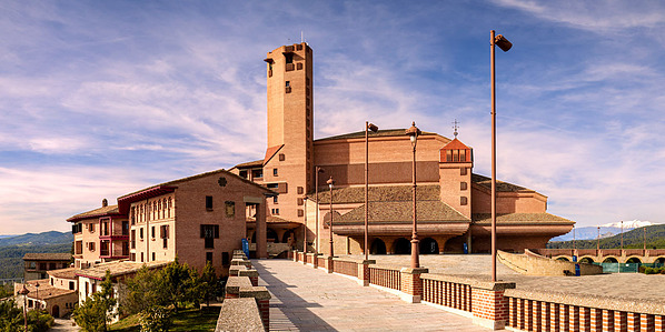 Wide-angle photo of Torreciudad Sanctuary, where expressive modern architecture meets the vast, natural beauty of the Spanish mountain setting.