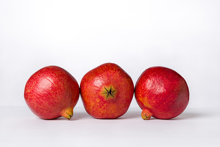 Three green chayotes arranged horizontally on a white background.