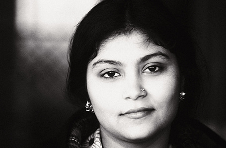 Street portrait in black and white of a young girl.