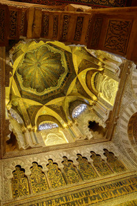The dome over the bay in front of the Mihrab in the Mosque-Cathedral of Córdoba, featuring intricate mosaics and stunning Islamic architecture.