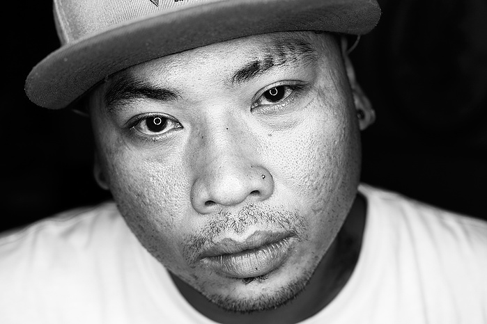 Black + White Fine Art Portrait of a Cambodian man, wearing a cap, with a neutral expression, silhouetted with a black background
Fine Art Portrait
Black + White Photography
Fine Art Gallery
Artistic Photography
Nicola Kinloch photography