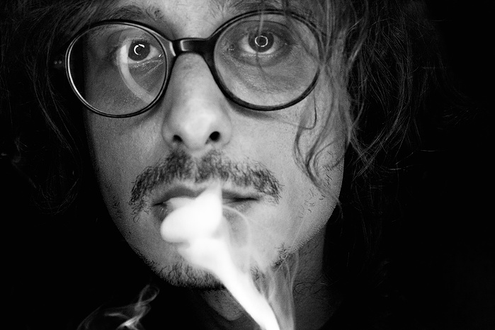 Black + White Fine Art Portrait of a Turkish man in his 30’s, wearing glasses and exhaling smoke, silhouetted with a black background
Portrait
Nicola Kinloch photography
Black + White Photography
Fine Art Gallery
Florence Biennale