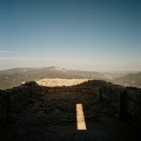 In the ruins of a castle overlooking an indiscernible landscape, on a terrace in the open air, the sun draws a rectangle of brilliant light among the shadows. France, Occitanie, Pyrenees-Orientales, Peyrepertuse, April 2022