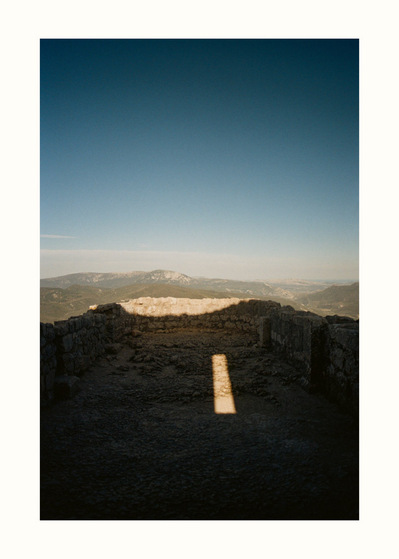 Fine Art print edition of 7 signed & numbered. 50x70 or 30x40 cm on Hahnemühle Bright White paper. Olivier Montay photographer. In the ruins of a castle, on a terrace, the sun draws a rectangle of light among the shadows. Film photography.