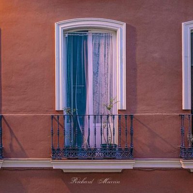 A high quality print available to buy of a three windows and Juliet balconies in Seville, Spain.