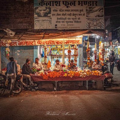 A high quality print available to buy of a flower stall at the market at Bhopal with a scene like the Last Supper, India.