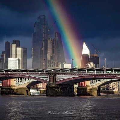 A high quality print available to buy of Blackfriars Bridge in London with the City of London and a rainbow in the background across the River Thames.
