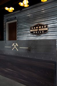 Metal wall treatment and check in counter design and build for Hammer and Nails 