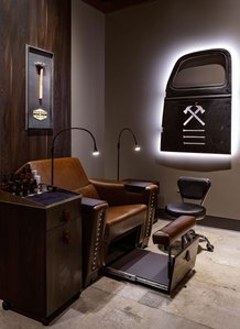 Custom designed manicure and pedicure chair with backlighted truck door for mens grooming franchise.