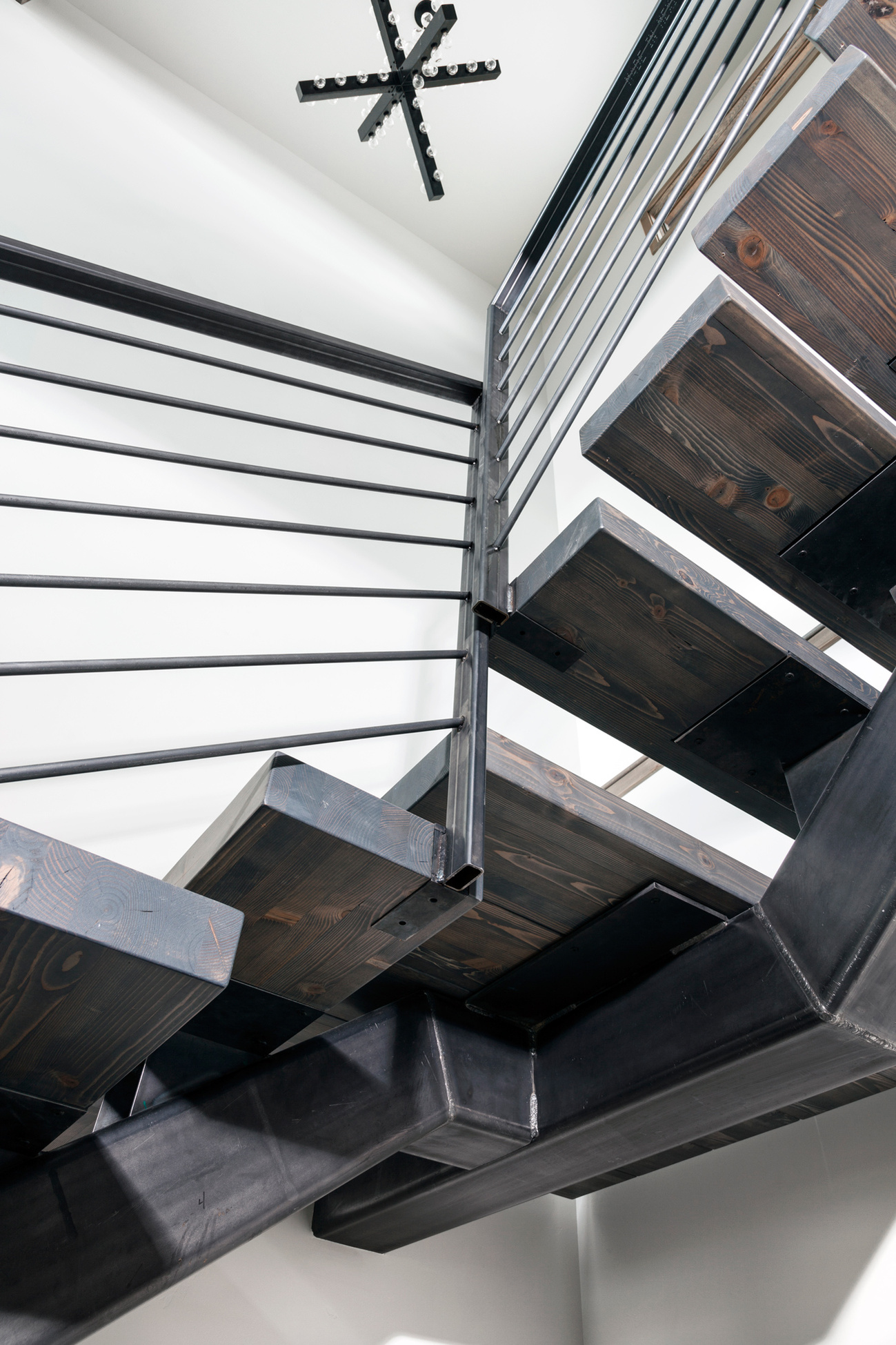 Custom stairs with hot rolled steel stringer and railing and custom stair treads