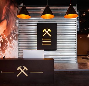 Reception area with custom desk, wall treatment and lighted sign