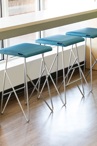 Counter and upholstered stools for Code Ninjas
