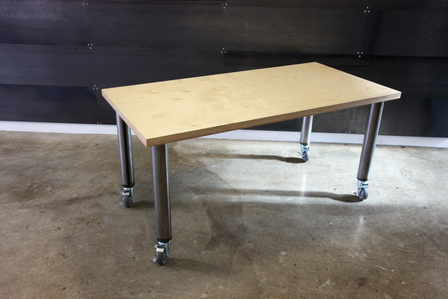 Modern work table with birch top, steel legs and casters