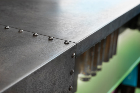 Store reception desk detail in galvanized steel and metal rivets