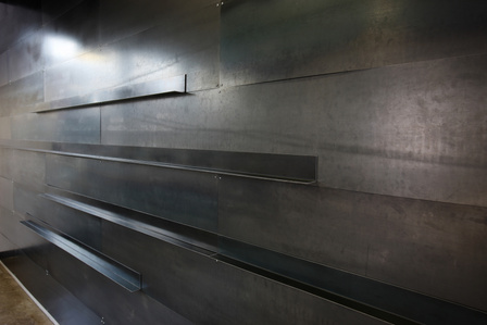 Steel wall covering and presentation ledges